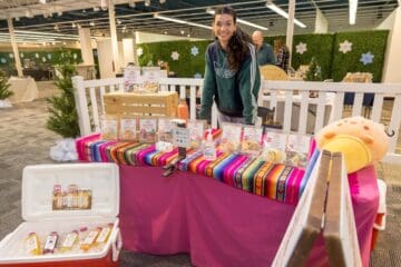 Ana's Twist booth with young woman smiling at camera at Winter Shop Local Market