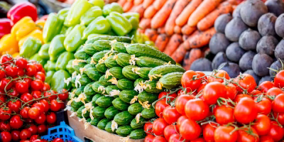 A colorful display of fresh fruits and vegetables at a bustling farmers market.