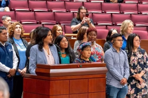 A group of people in a courtroom setting
