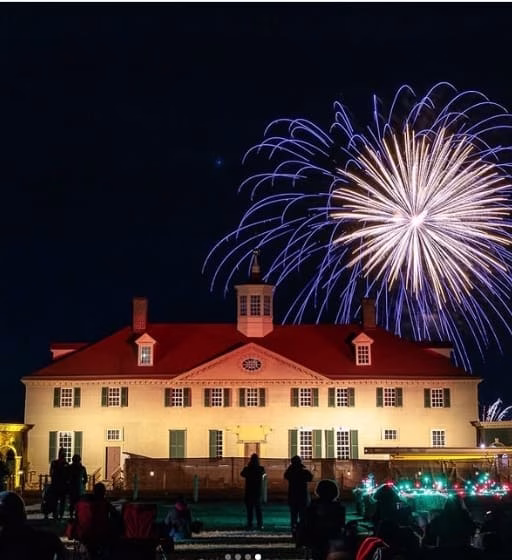 Fireworks exploding in the sky above a historic building