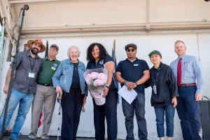 A group of people standing on stage, posing for a photo