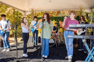 Group of young people performing on stage, showcasing their musical talents