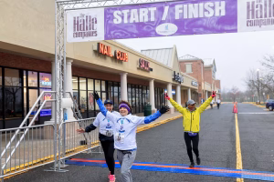 Three women crossing the finish line of a race