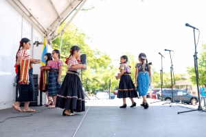 A group of young girls performing on stage, showcasing their talents and skills