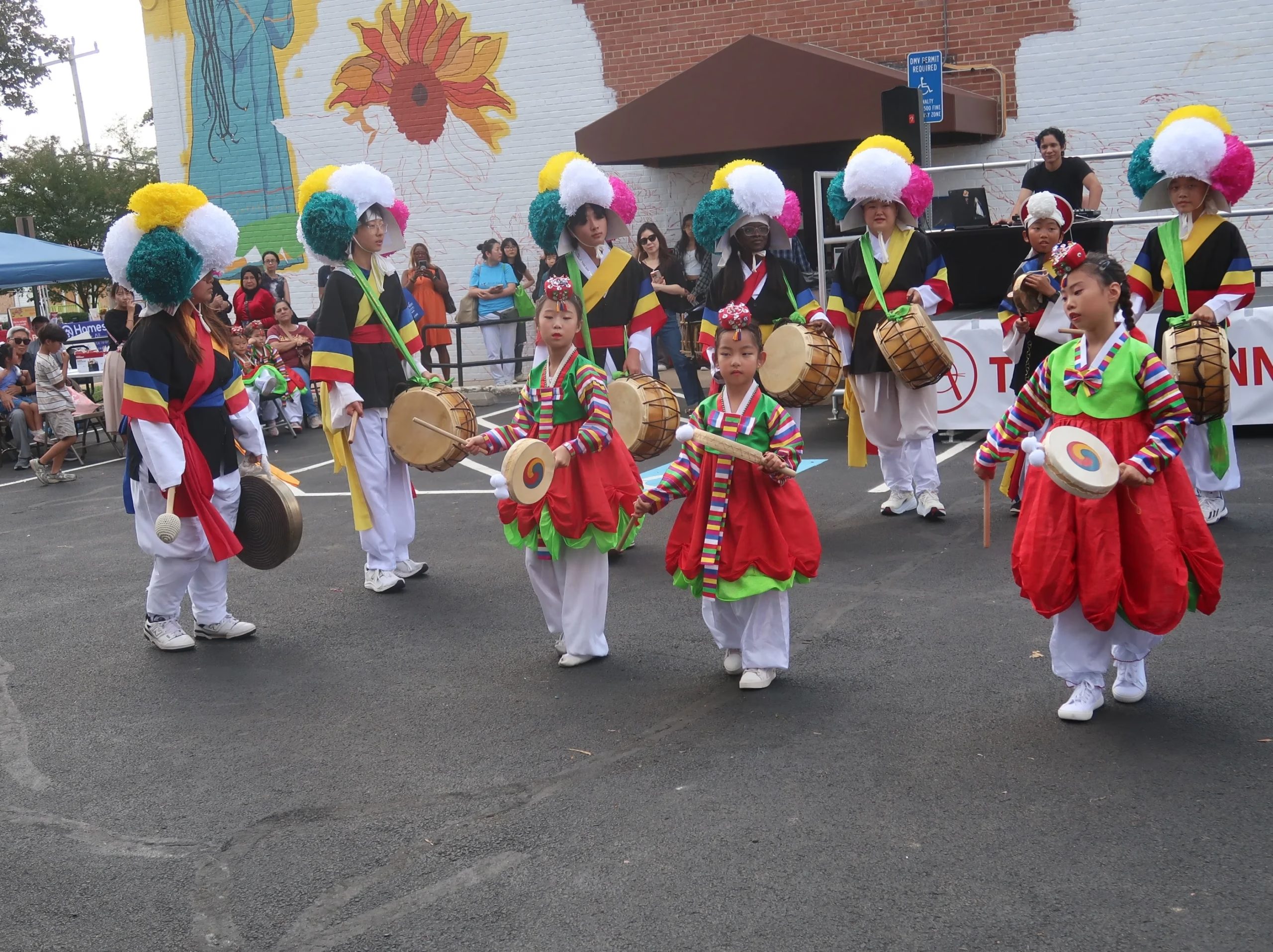 Group of children in colorful costumes performing traditional Korean dance