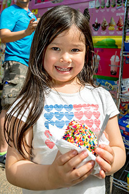 Girl with ice cream smiling at Braddock Bark