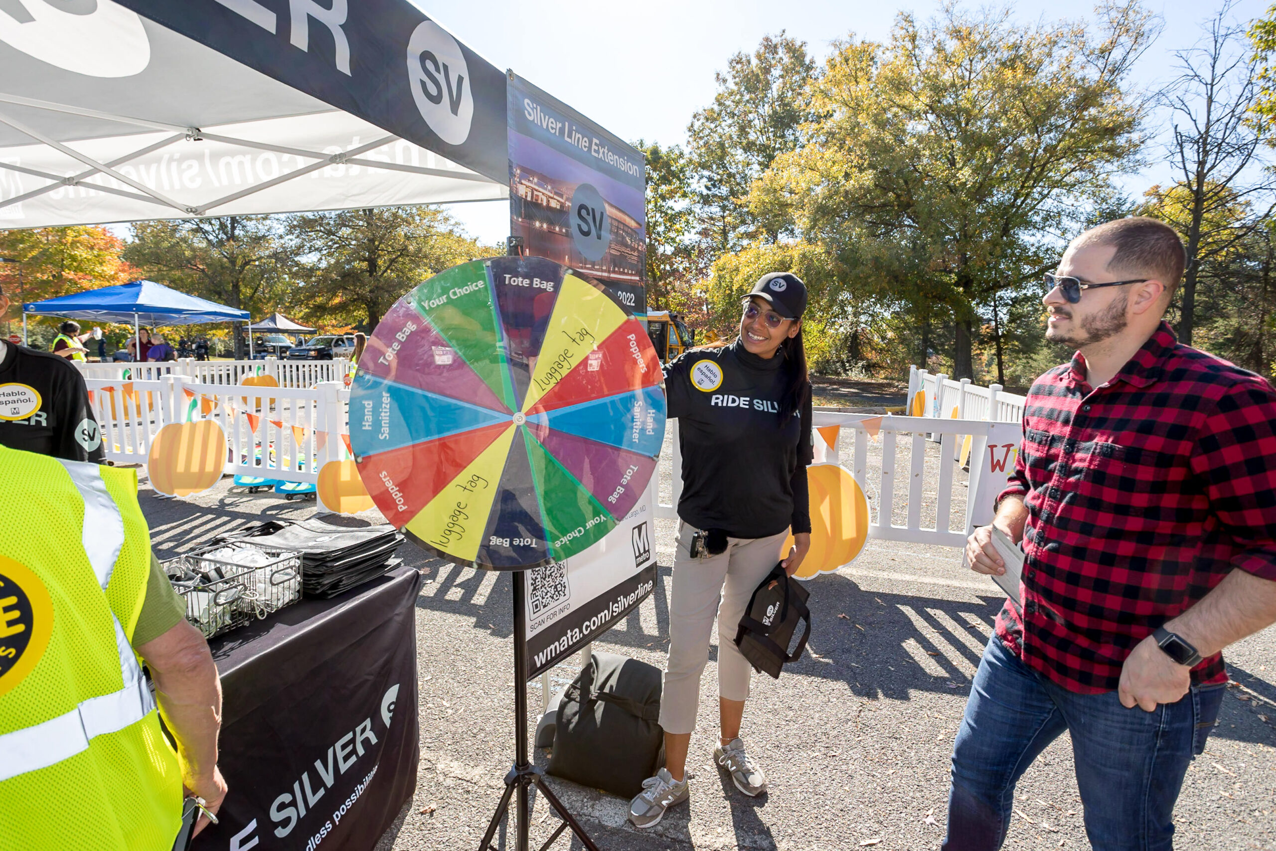 picture of a man spinning the prize wheel at the metro exhibitor tent