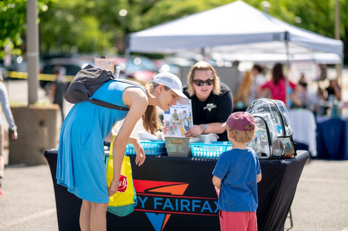 Ready Fairfax booth staffers talking to family at Culmore Day 2023