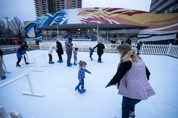 photo of pairs of parents and children on an ice skating rink